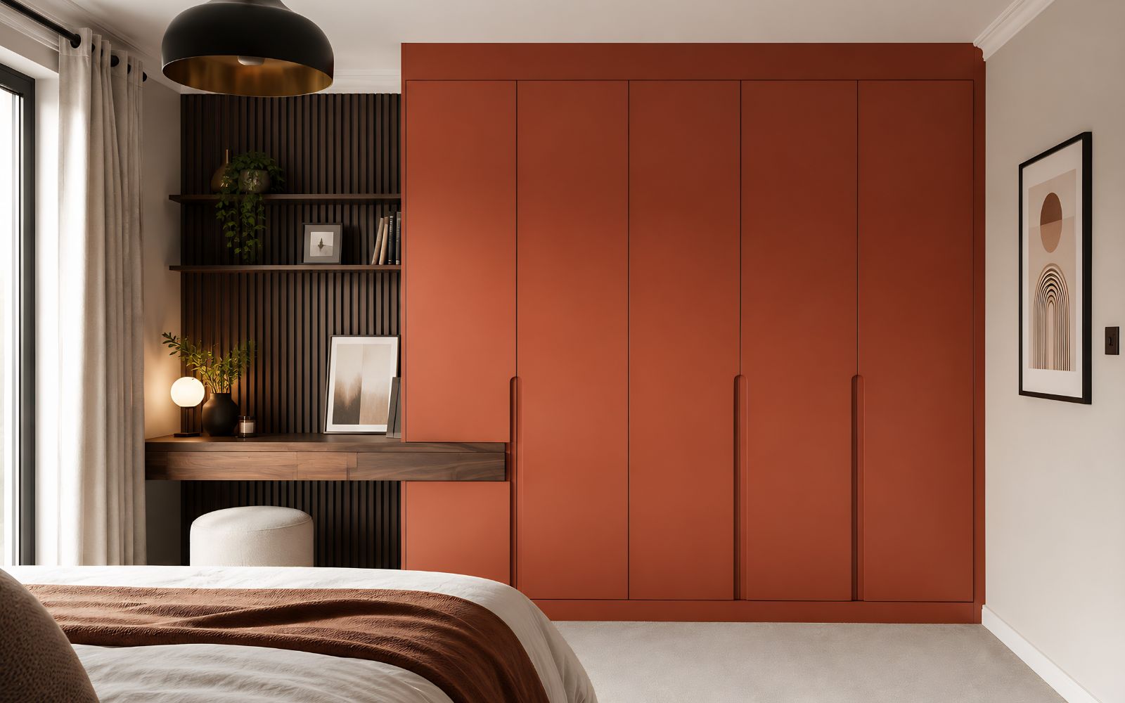 Modern bespoke bedroom wardrobe in terracotta with flat doors, integrated desk, open shelves and dark timber slatted wall panelling.