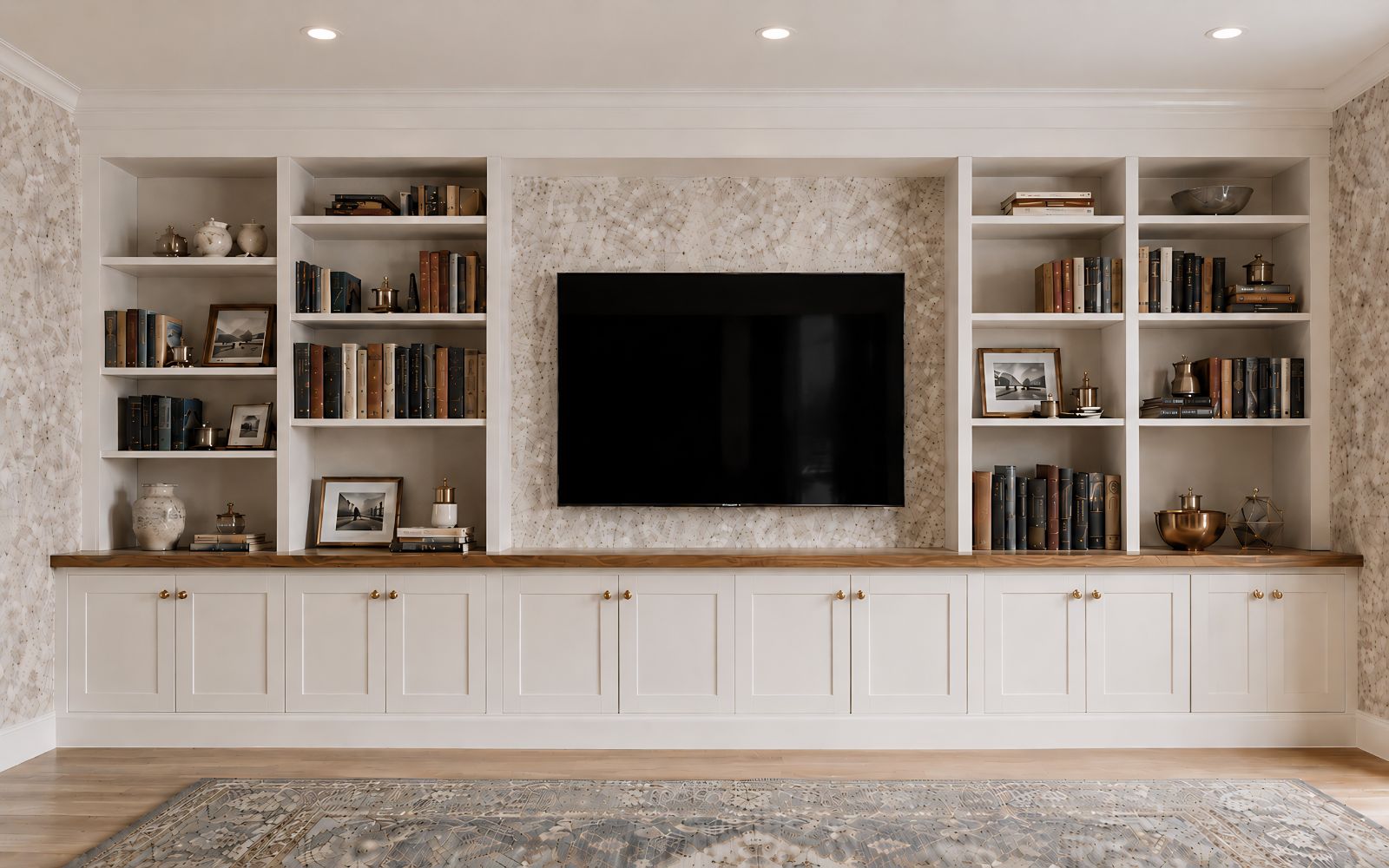 Bespoke fitted media wall with TV, open bookshelves, shaker-style base cabinets and timber worktop